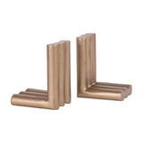 Libra Interiors ribbed cast aluminium L-shaped bookends in antique brass, shown as a facing pair with fluted cylindrical columns on a white background.