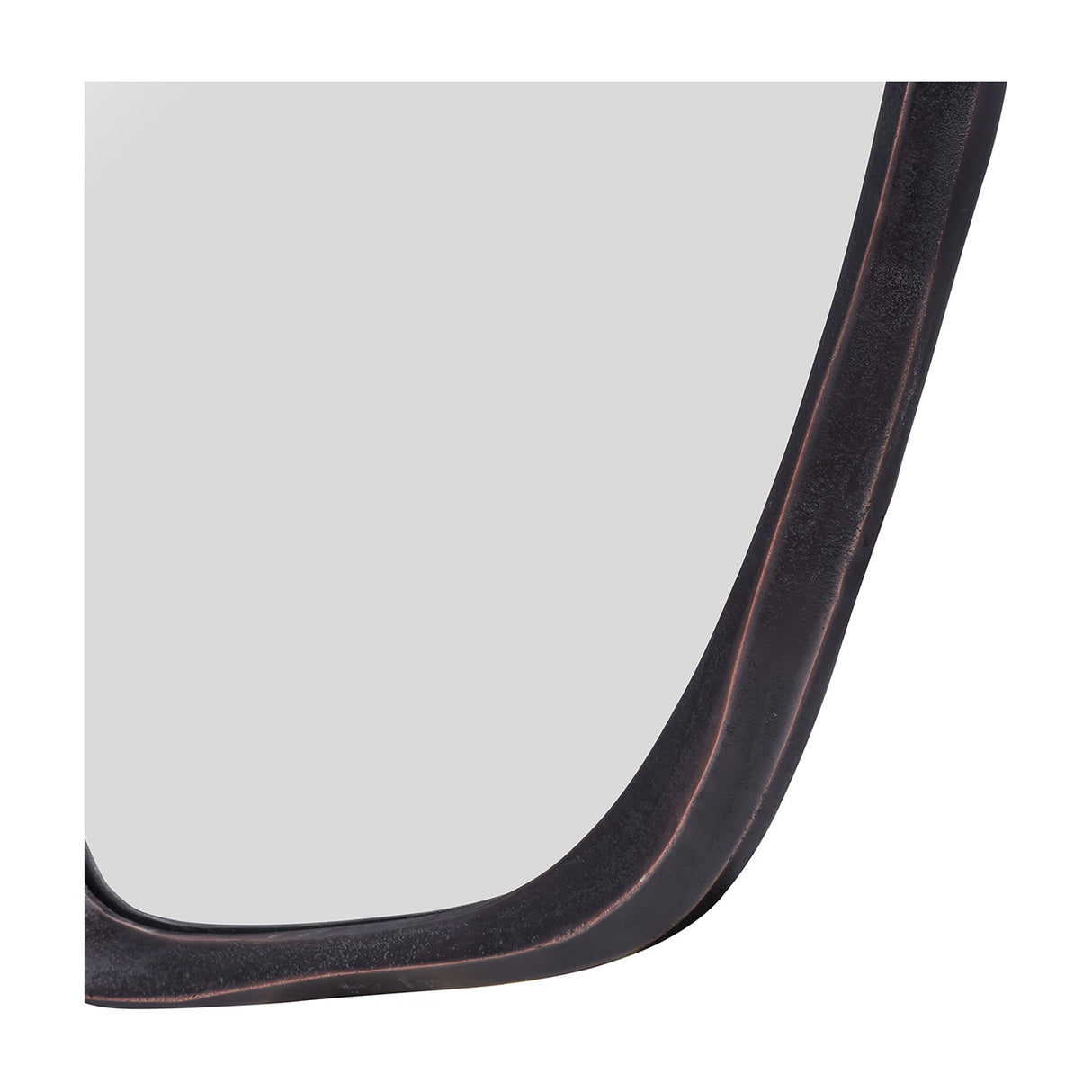 Close-up of the Libra Interiors textured cast aluminium organic wall mirror's lower corner, showing the curved bronze frame and glass panel.