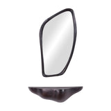 Libra Interiors textured cast aluminium wall mirror with an organic irregular outline in bronze, shown above a curved bronze wall shelf on a white background.