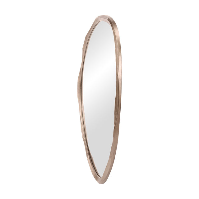 Libra Interiors textured organic cast aluminium wall mirror in antique brass, tall asymmetric sculpted frame with clear glass, shown on a white background.