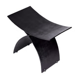 Libra Interiors Cast Aluminium Curved Stool in black with arched crossed legs and concave seat in textured finish, shown on a white background.