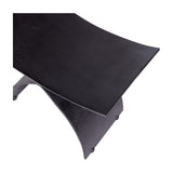 Close-up of Libra Interiors Cast Aluminium Curved Stool in black, showing the concave seat and arched leg with raw textured charred finish.
