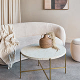 Libra Interiors Bone Inlay Round Brass Coffee Table in white with fluted edge and gold legs, styled in a neutral living room with bouclé sofa and vase.