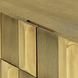 Close-up of Libra Interiors Sculpted Brass Large Sideboard showing the antique brass tiled front with vertical ridges and shagreen-textured top surface.