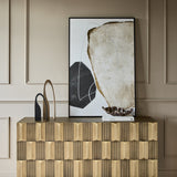Libra Interiors Sculpted Brass Large Sideboard in antique brass styled with abstract art, arched sculptures and a shell dish against panelled walls.