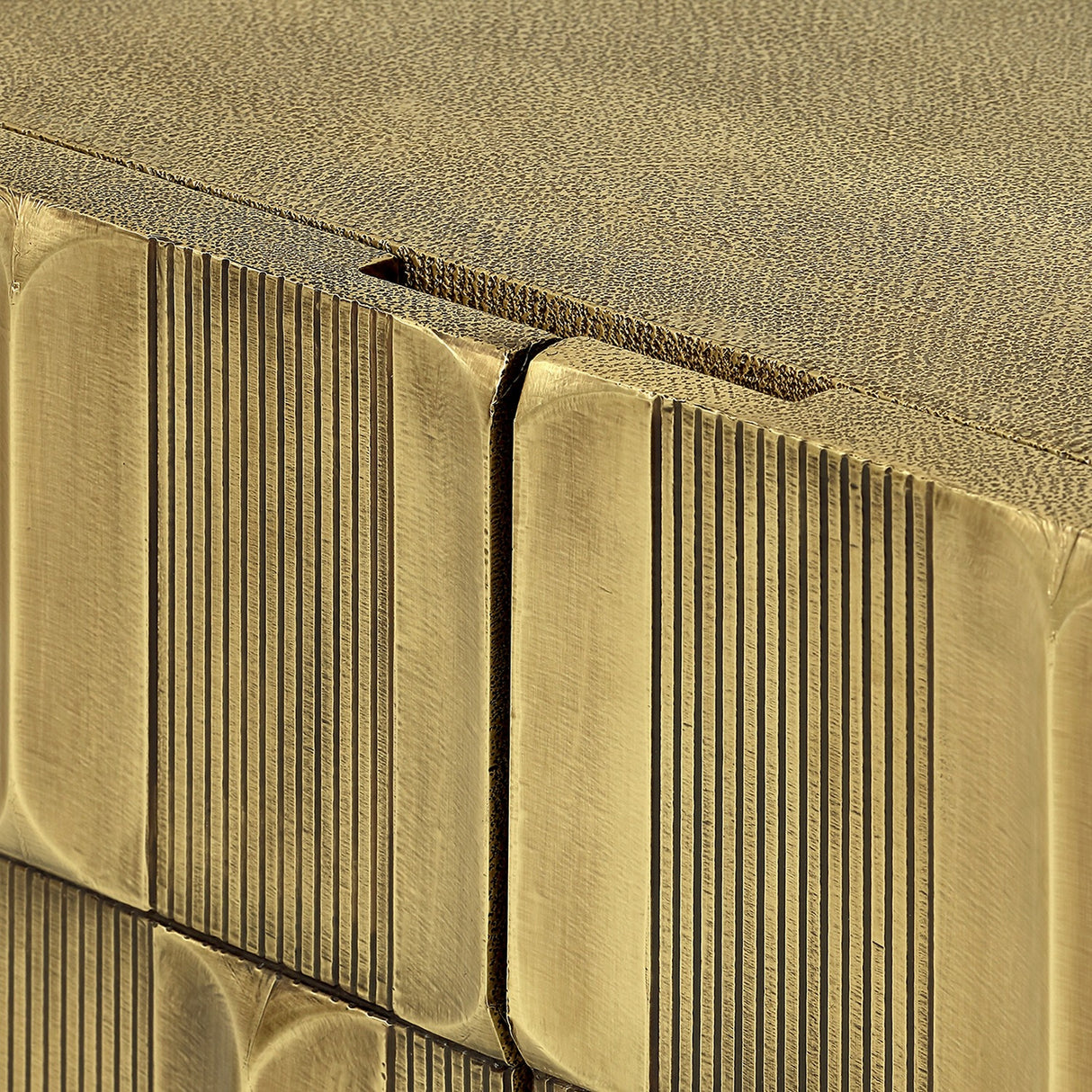 Close-up of Libra Interiors Textured Brass 2 Door Cabinet showing sculpted antique brass tiles on the doors and shagreen-effect top surface.
