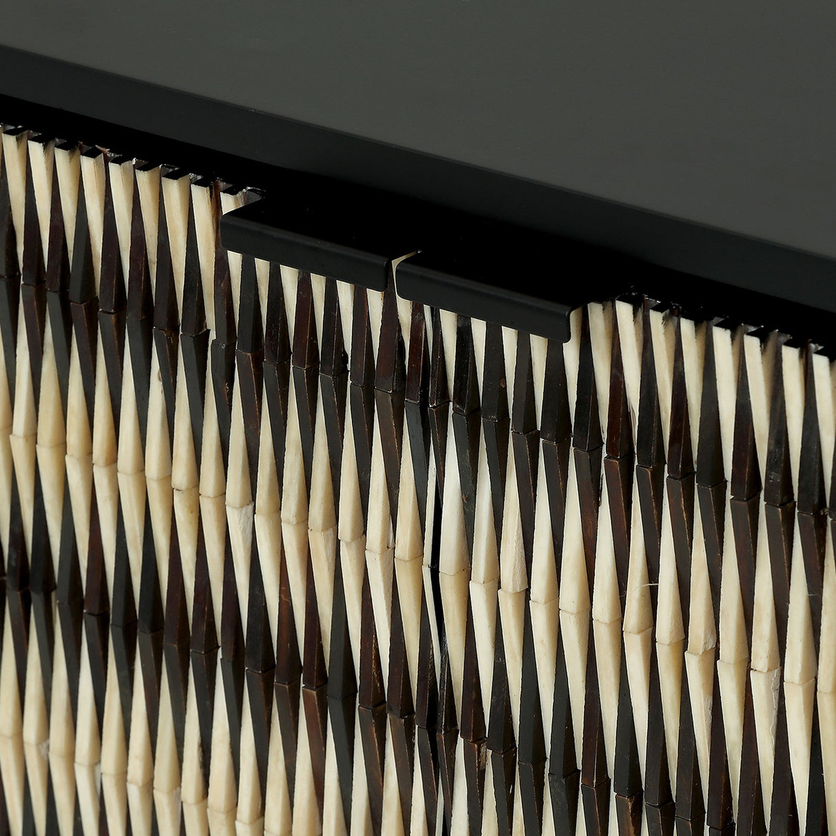 Close-up of Libra Interiors Bone Inlay Raised Pattern Sideboard in black, showing the raised bone inlay doors in black and ivory with slim black handles.