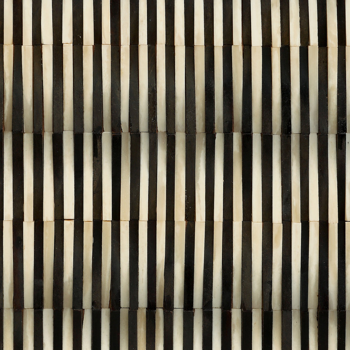 Close-up of Libra Interiors Bone Inlay Raised Pattern Sideboard door showing vertical black and ivory bone strips in a rhythmic, tactile pattern.