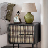 Libra Interiors Bone Inlay 2-Drawer Bedside Table in black with ivory patterned drawer fronts, styled beside a bed with a green lamp and silver clock.