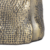 Close-up of Libra Interiors Woven-Effect Cast Aluminium Candle Holder showing the textured basket-weave surface and antique brass ombre finish.