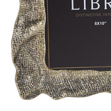 Close-up of Libra Interiors Woven-Effect Cast Aluminium 8x10" photo frame corner, showing rippled organic edge and textured antique brass finish.
