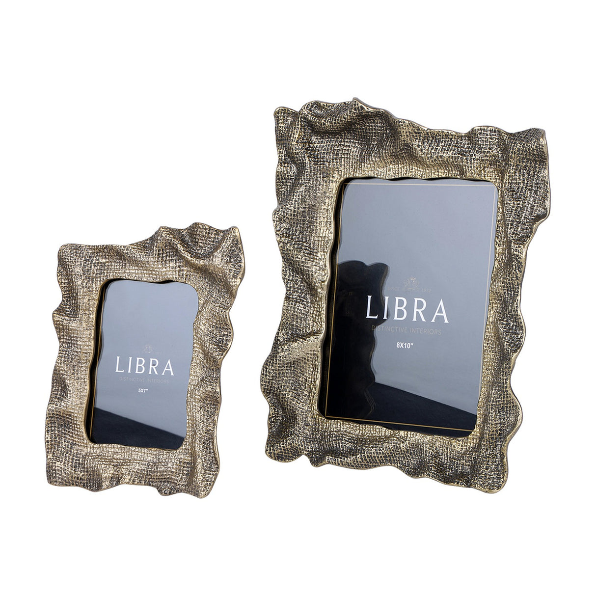 Libra Interiors woven-effect cast aluminium photo frames in antique brass, shown in 5x7" and 8x10" portrait sizes with rippled organic edges, on white.