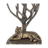Libra Interiors Antiqued Brass Tiger Table Lamp base detail showing a resting tiger beneath bare branching limbs with etched stripes and bark texture.