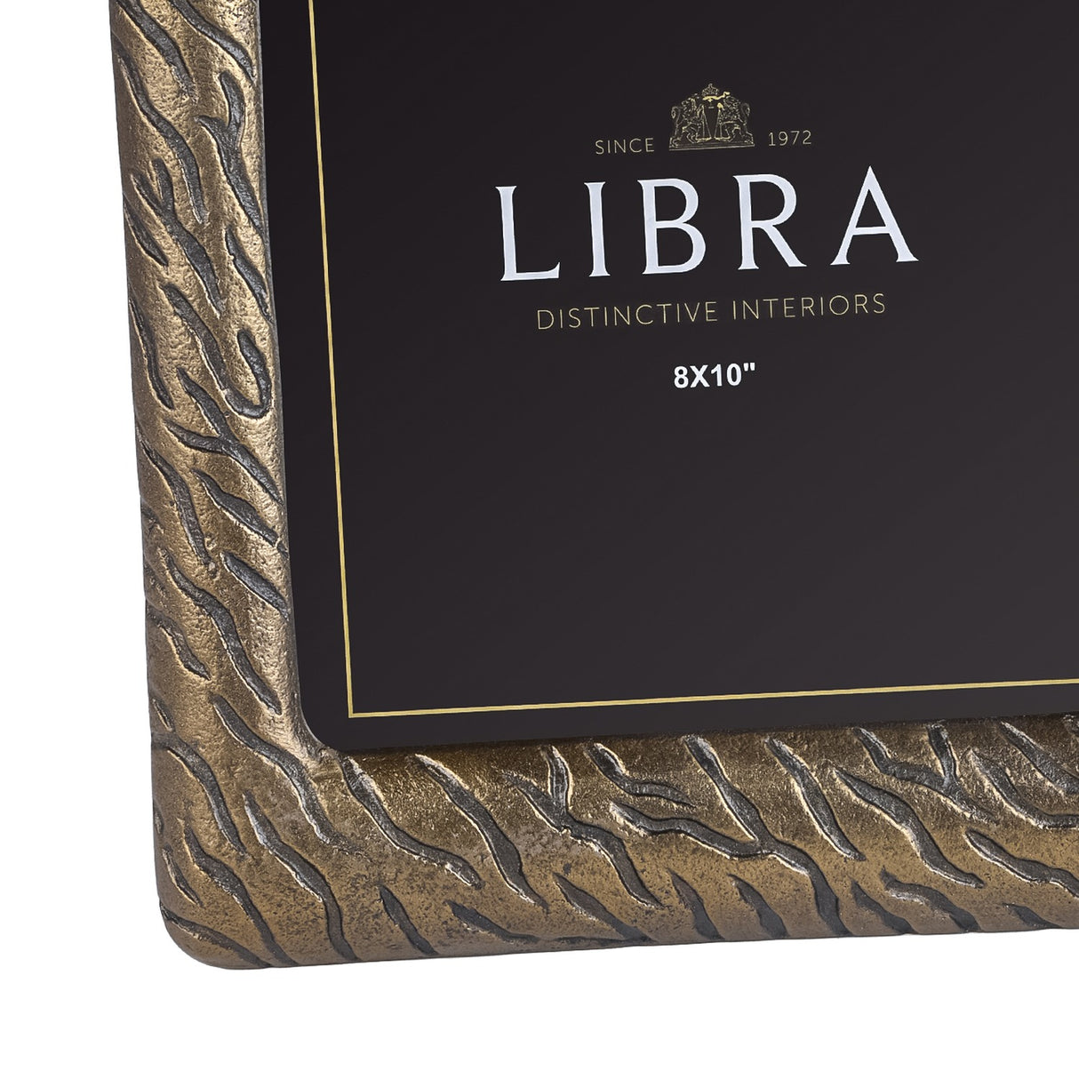 Close-up of the Libra Interiors Etched Cast Aluminium 8x10" Photo Frame corner, showing tiger-stripe etched texture in antique brass and gold.