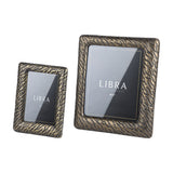 Libra Interiors etched cast aluminium photo frames in antique brass with tiger-stripe texture, shown in 5x7 and 8x10 portrait sizes on a white background.