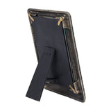 Rear view of the Libra Interiors Etched Tiger cast aluminium photo frame in antique brass, showing the black backing board, brass screws and integrated stand.