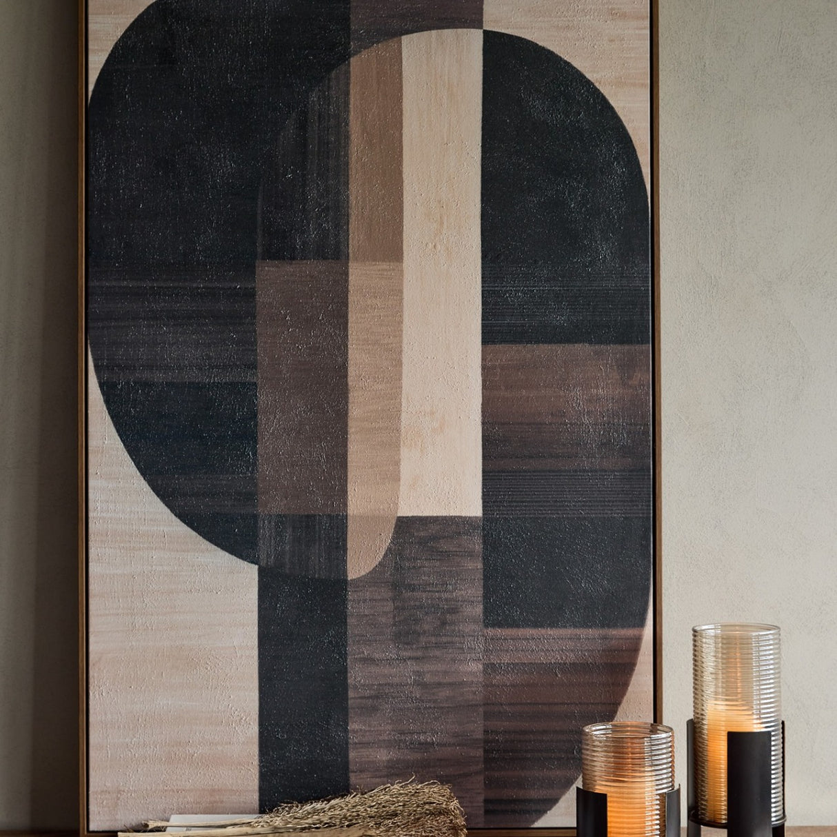 Libra Interiors Textured Geometric Framed Canvas Wall Art in black, brown and cream tones, displayed above a console with two ribbed glass candle holders.