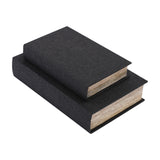 Libra Interiors Book-Style Linen Storage Boxes in black, stacked pair with woven linen covers and page-edge sides, shown on a plain white background.