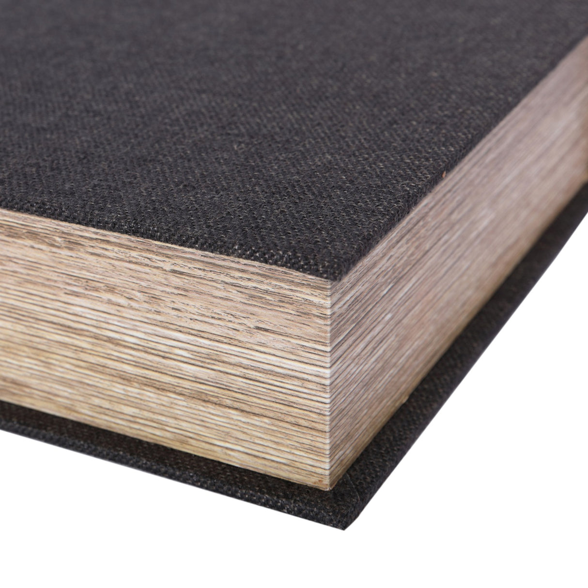 Close-up of Libra Interiors Book-Style Linen Storage Box in black, showing the woven linen cover and layered wood edge resembling book pages.
