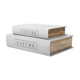 Libra Interiors linen book-style storage boxes in white with black Nature lettering, stacked as a set of two showing page-effect edges on a plain background.