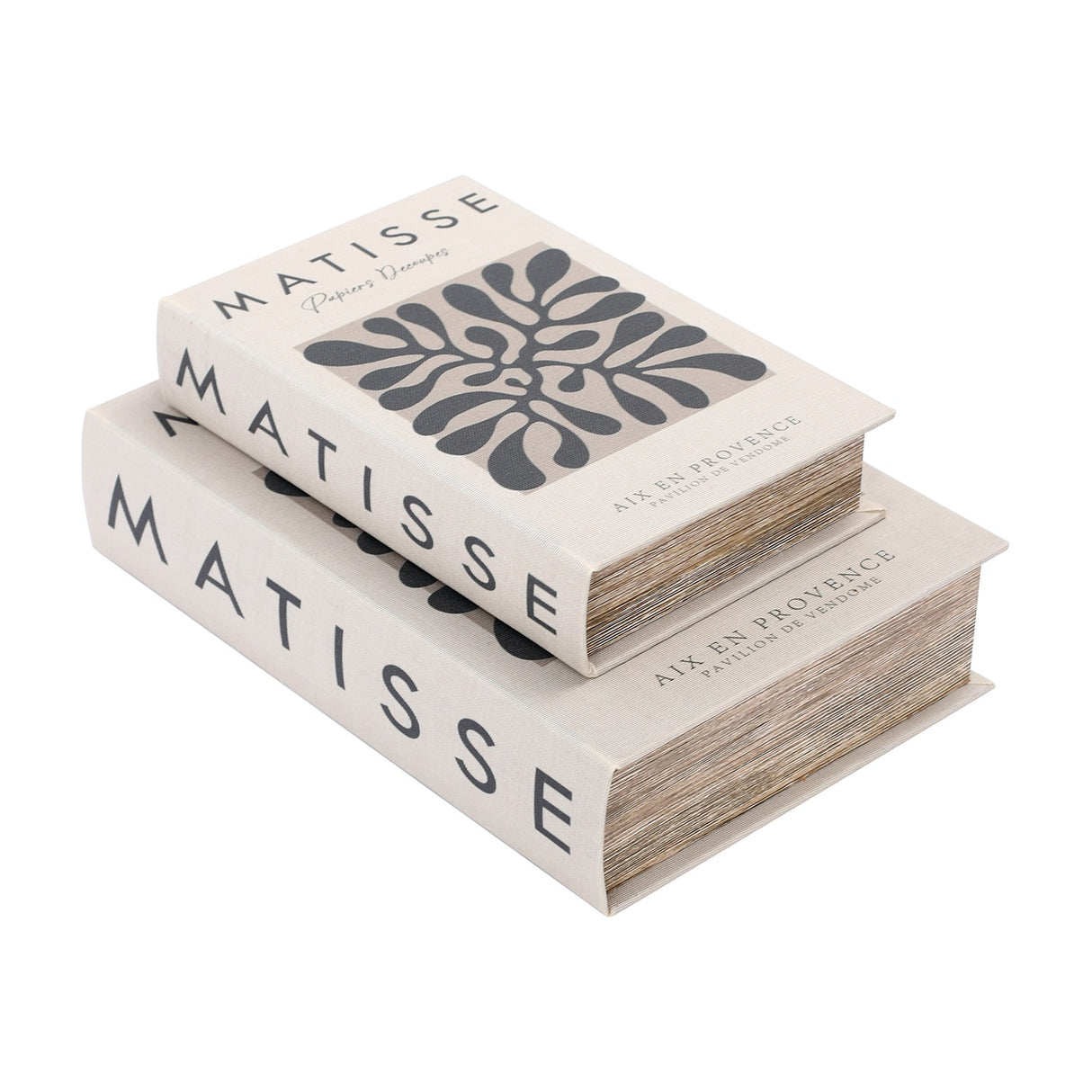 Libra Interiors Matisse linen book-style storage boxes in white with charcoal typography and abstract cut-out motif, stacked on a plain background.