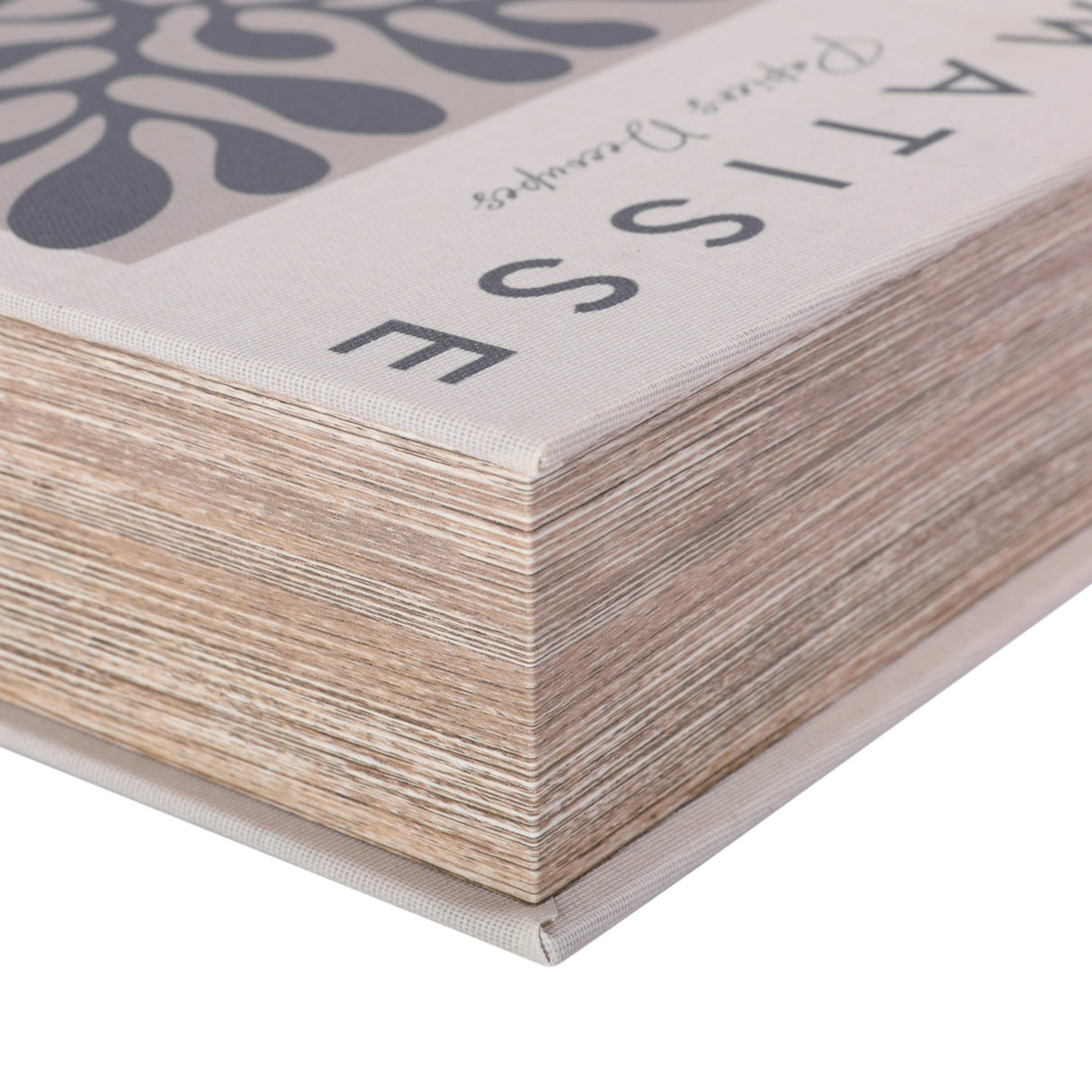 Close-up of the Libra Interiors Linen Book-Style Storage Box in white, showing the linen-wrapped edge, typographic Matisse title and layered pages detail.