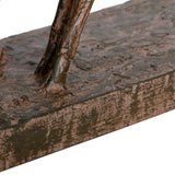 Close-up of the rectangular base and slender legs of the Libra Interiors Rustic Leaping Fawns resin sculpture, showing weathered bark-like brown patina.
