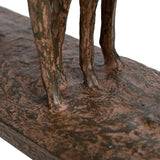 Close-up of the textured brown resin base and slender legs of the Libra Interiors Textured Trio of Stags Sculpture, showing its weathered rustic finish.