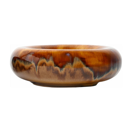Libra Interiors Reactive Glaze Rounded Stoneware Bowl in brown with caramel, ochre and mocha drip tones and a high shine finish, on a white background.