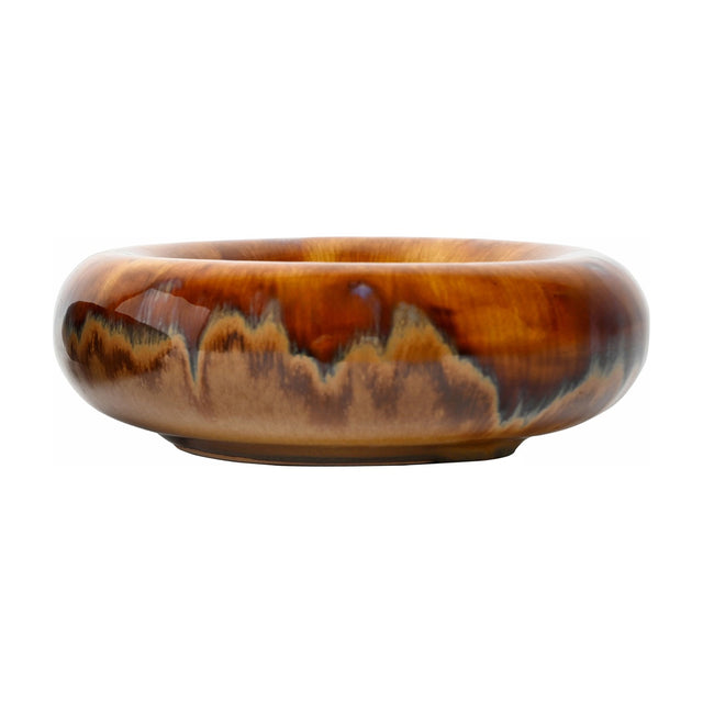 Libra Interiors Reactive Glaze Rounded Stoneware Bowl in brown with caramel, ochre and mocha drip tones and a high shine finish, on a white background.
