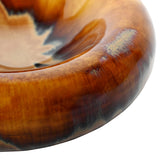Close-up of Libra Interiors Reactive Glaze Rounded Stoneware Bowl in brown, showing the bulging rim and glossy caramel, ochre and mocha glaze pooling.