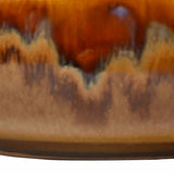 Close-up of Libra Interiors Reactive Glaze Rounded Stoneware Bowl in brown, showing caramel, ochre and mocha drip glaze over a high shine ceramic surface.