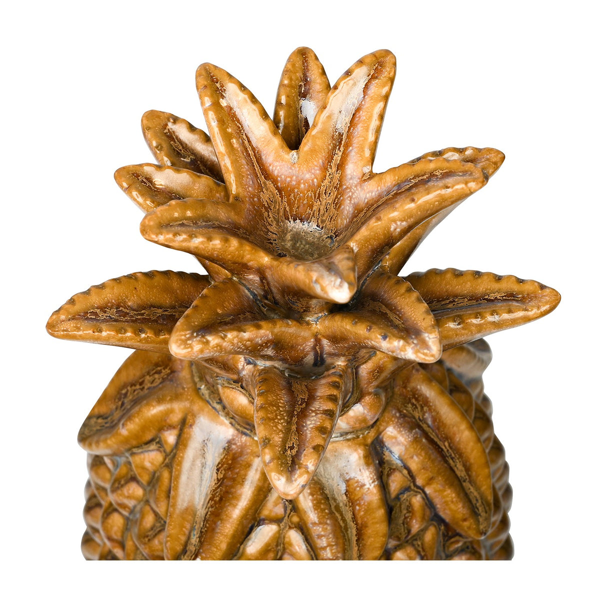 Close-up of the Libra Interiors Glazed Ceramic Pineapple Sculpture crown showing textured brown and gold reactive glaze on the spiky leaves.