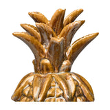 Libra Interiors glazed ceramic pineapple sculpture in brown and gold, close-up of the textured spiky crown and upper body on a white background.