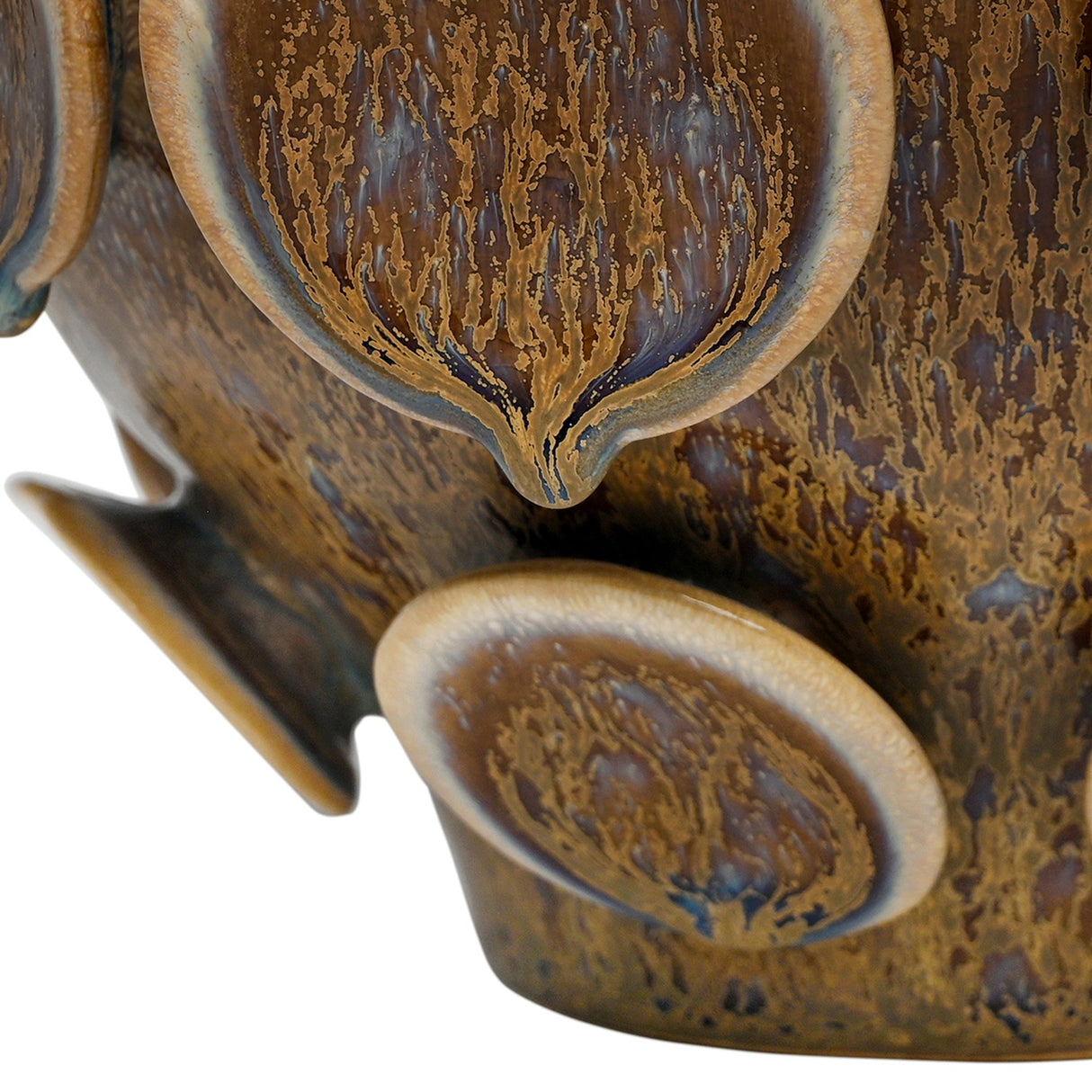 Close-up of Libra Interiors Reactive Glaze Raised Circle stoneware planter in brown, showing mottled glossy glaze pooling across the raised circular discs.