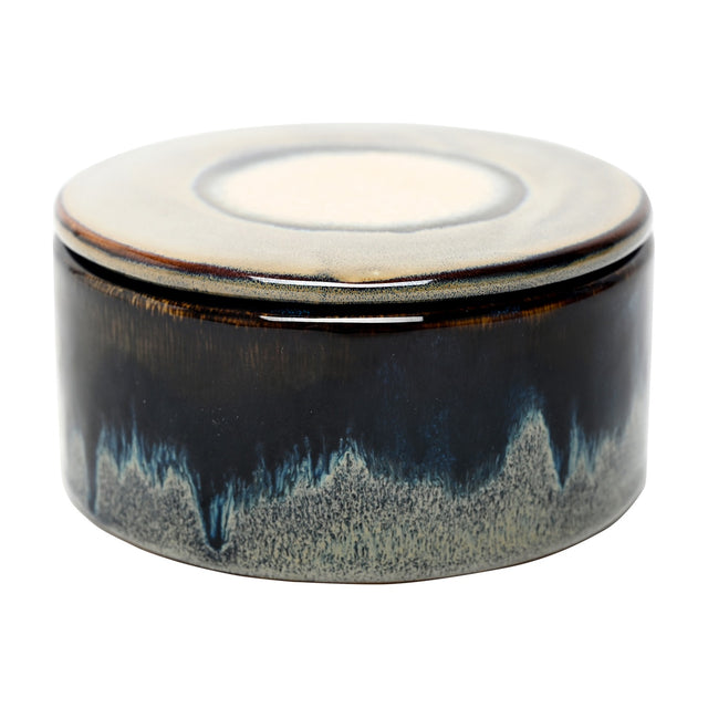 Libra Interiors Reactive Glaze Ceramic Rose Candle in blue, a round lidded stoneware vessel with inky blue pooling glaze and cream-toned lid centre.