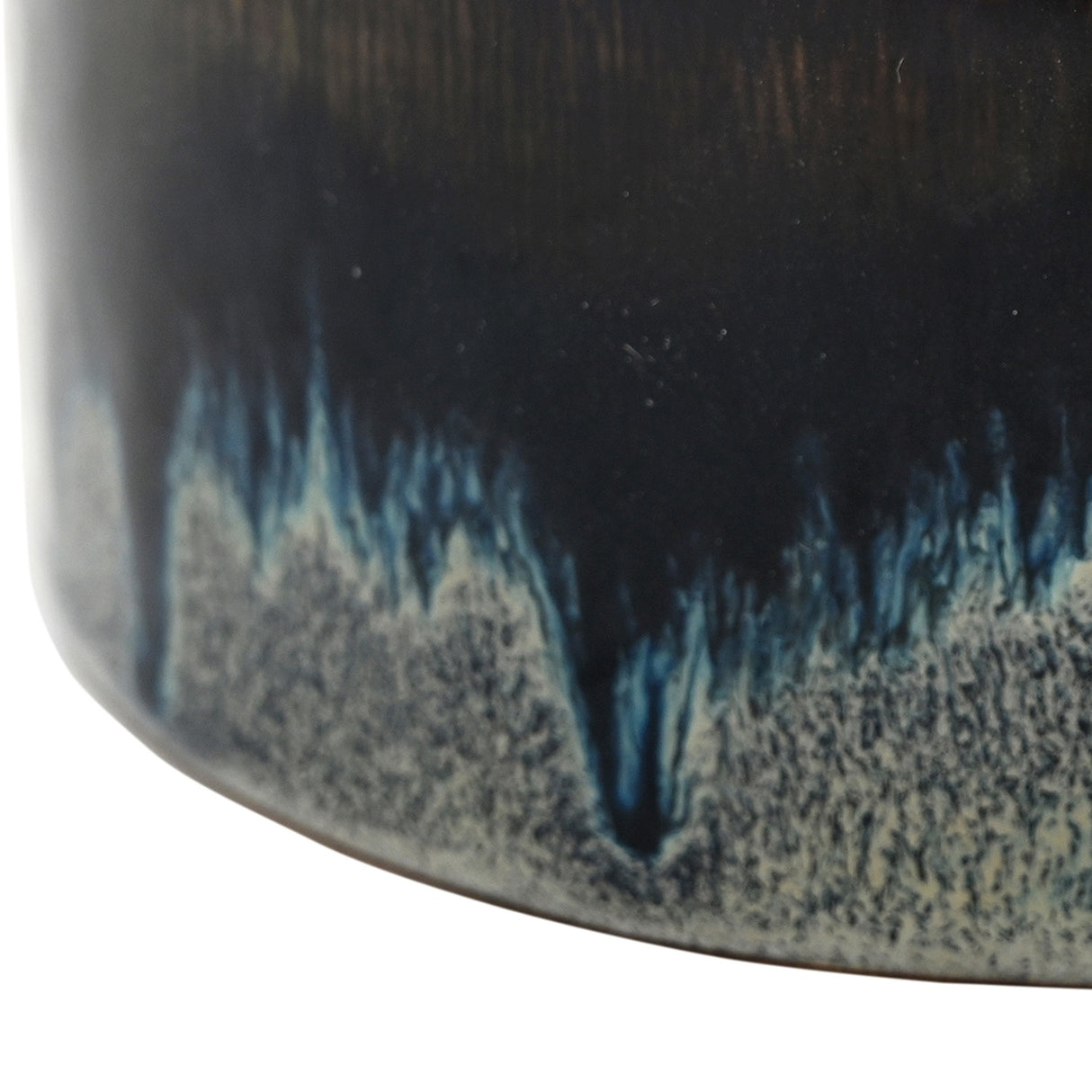 Close-up of Libra Interiors Reactive Glaze Ceramic Rose Candle in blue, showing inky blue and steel grey glaze pooling over a pale speckled base.