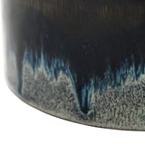 Close-up of Libra Interiors Reactive Glaze Ceramic Rose Candle in blue, showing inky blue and steel grey glaze pooling over a pale speckled base.