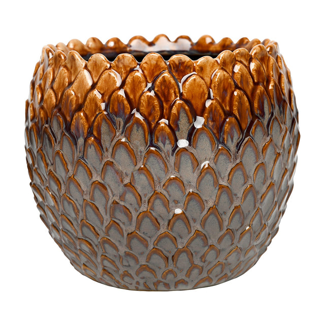 Libra Interiors Scale-Textured Ceramic Planter in brown, a rounded pot with a glossy scale-like surface fading from amber at the rim to grey below.
