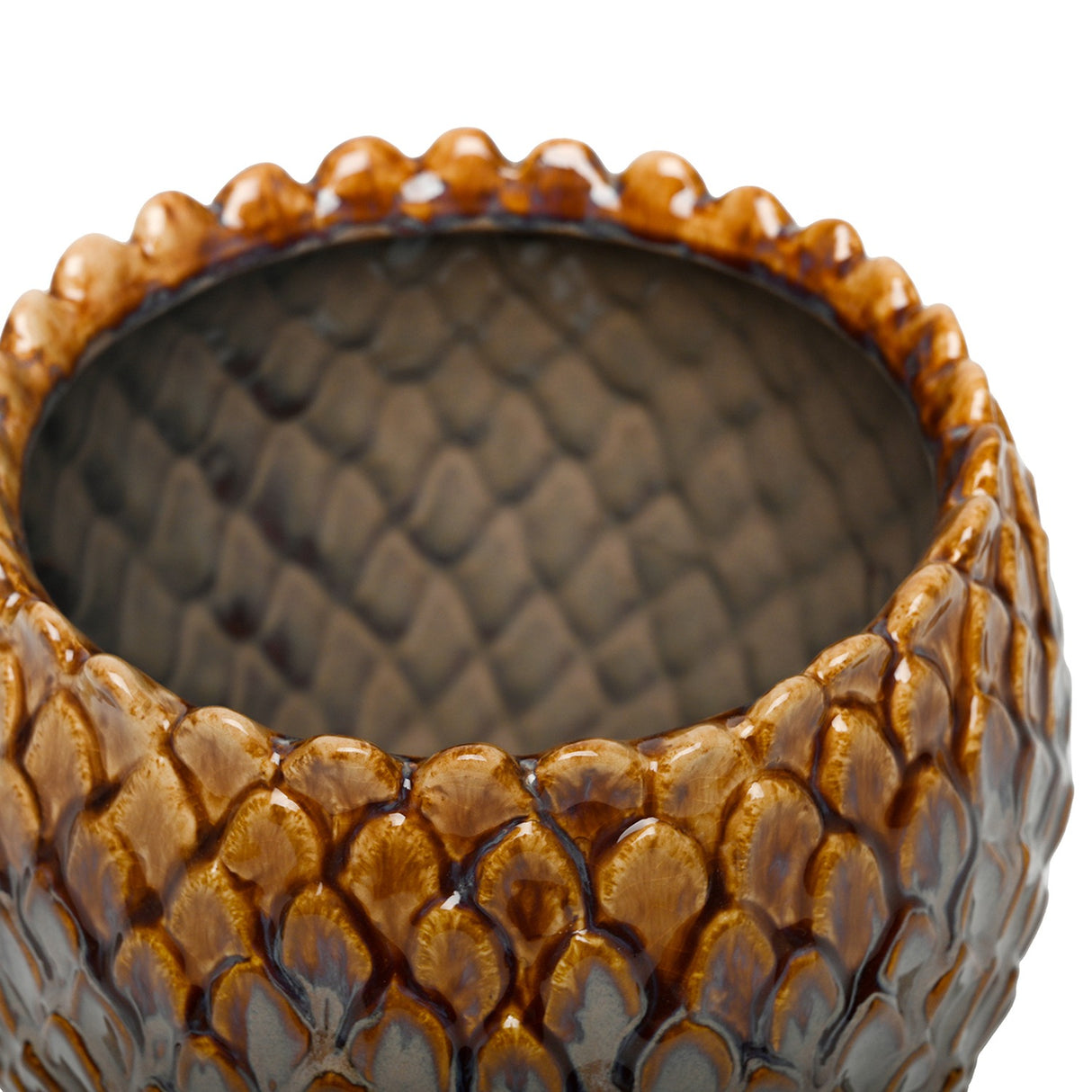 Close-up of the Libra Interiors Scale-Textured Ceramic Planter in brown, showing the glossy amber rim, scale-patterned exterior and fully glazed grey interior.