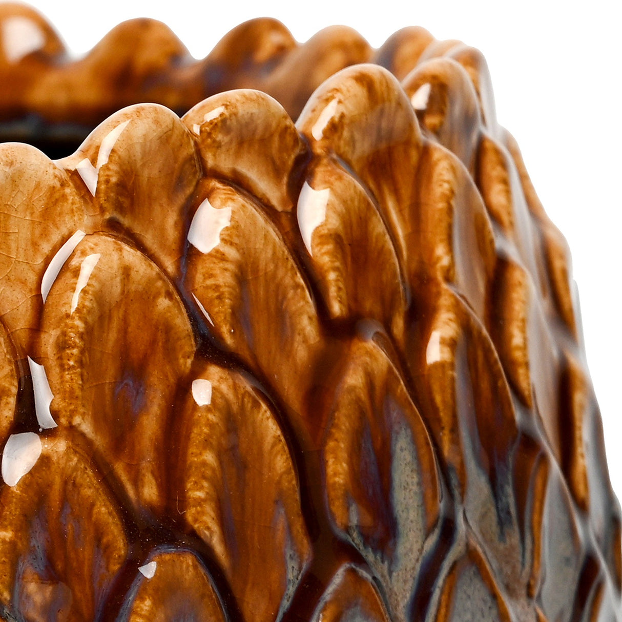 Close-up of the Libra Interiors Scale-Textured Ceramic Planter in brown, showing the glossy amber and charcoal reactive glaze over sculpted scale-like relief.