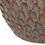 Close-up of Libra Interiors Scale-Textured Ceramic Planter in brown, showing the glossy reactive glaze with amber and grey scale-like moulded pattern.