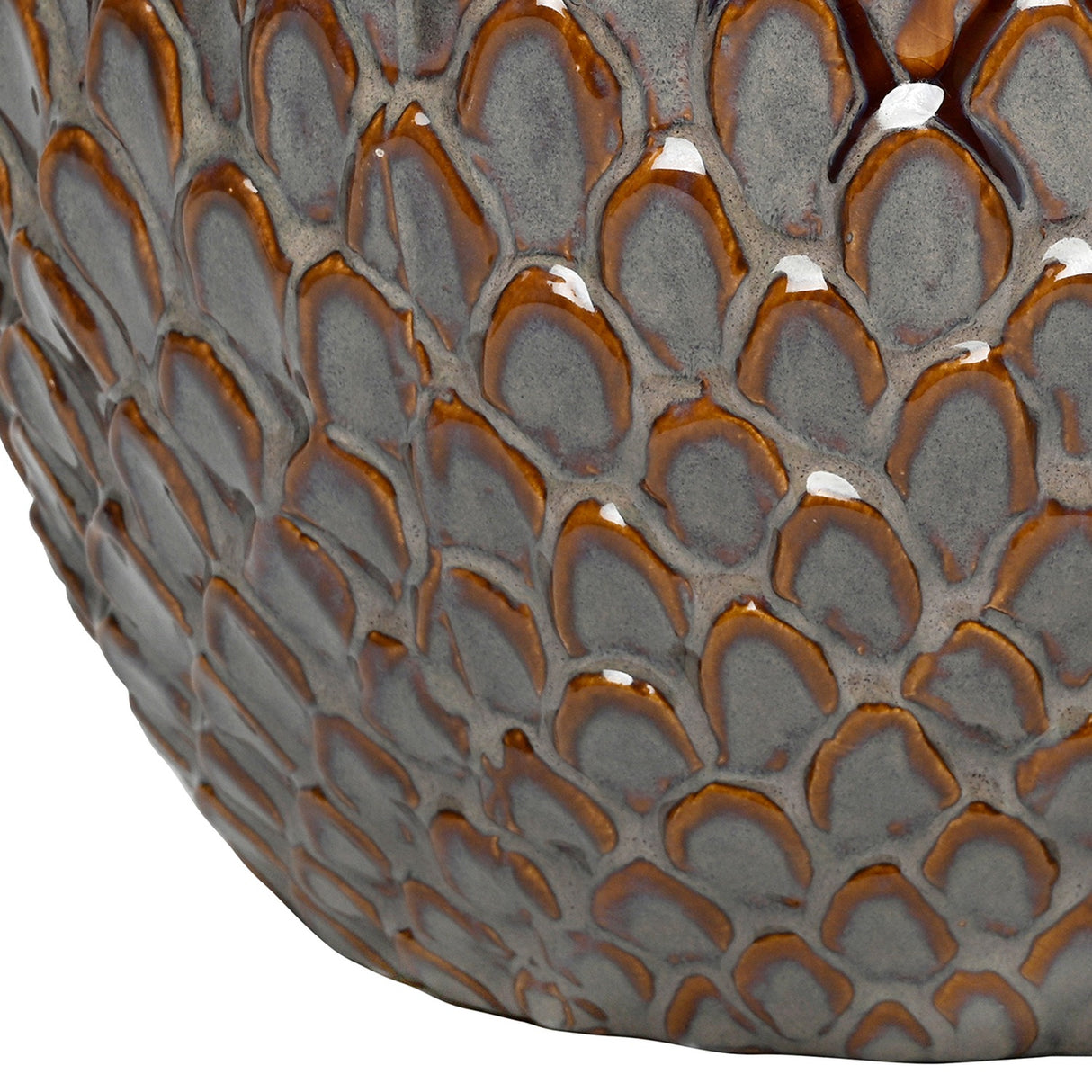 Close-up of the Libra Interiors Scale-Textured Ceramic Planter showing the glossy overlapping scale pattern in graded amber and charcoal grey tones.
