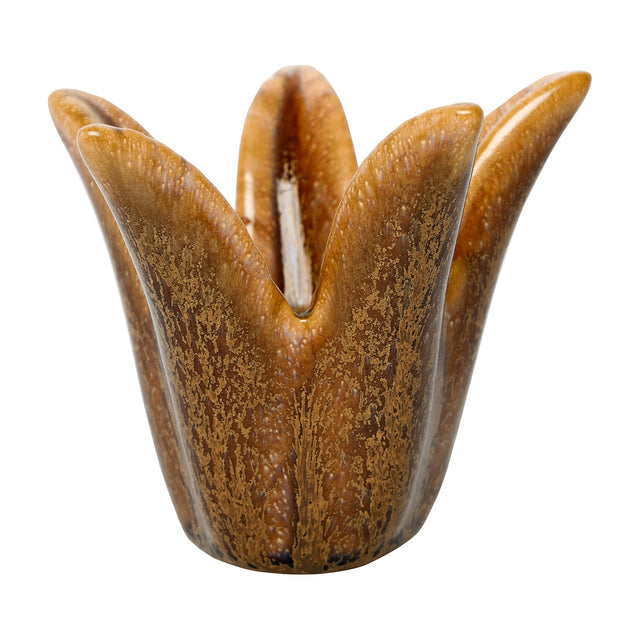 Libra Interiors Petal Reactive Glaze ceramic candle holder in brown, with four sculpted petals and a speckled amber glossy finish, on a white background.