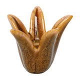 Libra Interiors Petal Reactive Glaze ceramic candle holder in brown, with four sculpted petals forming an open cup, shown on a plain white background.