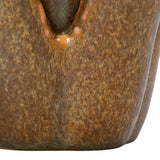 Close-up of the Libra Interiors Petal Reactive Glaze ceramic candle holder showing mottled warm brown tones and a glossy petal edge.