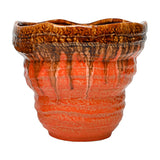 Libra Interiors Reactive Glaze Ceramic Planter in orange with a textured body and glossy brown drip glaze running from the rim, on a white background.