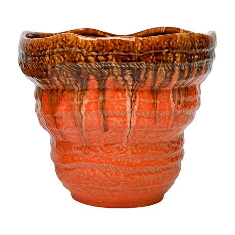 Libra Interiors Reactive Glaze Ceramic Planter in orange with a textured body and glossy brown drip glaze running from the rim, on a white background.