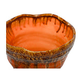 Libra Interiors Reactive Glaze ceramic planter in orange with brown drip glaze rim, textured ridged body and glossy interior, shown close-up on white.