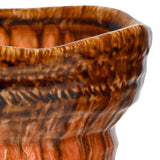 Close-up of the Libra Interiors Reactive Glaze Ceramic Planter showing the wavy rim, rippled body and glossy brown-to-orange drip glaze.